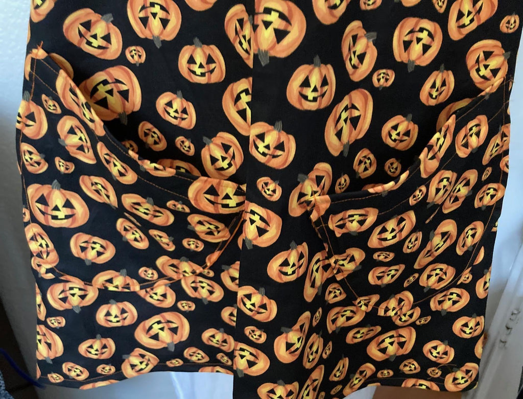 HALLOWEEN PUMPKINS Scattered on black fabric reversible cross back apron