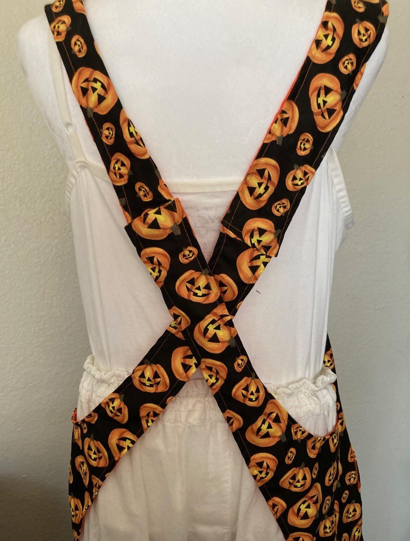 HALLOWEEN PUMPKINS Scattered on black fabric reversible cross back apron